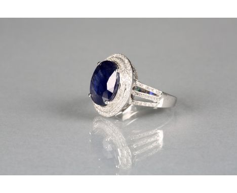 14k white gold and diamond set ring with an oval cut blue sapphire approx. 6.75ct, total weight of diamonds approx. 1.10ct