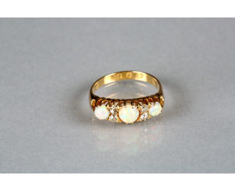 Ladies Edwardian 18 carat gold diamond and opal ring, three opals with four old cut diamonds 