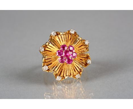 Ladies 18 carat gold ruby and diamond ring, textured wavy circular form with a central cluster of seven stone rubies, with ei