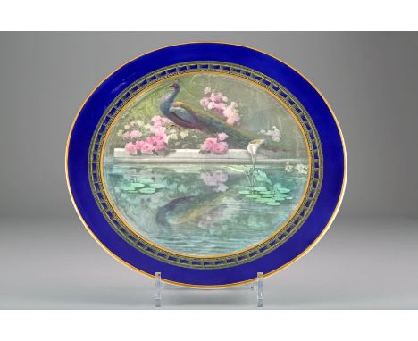 Royal Worcester charger, blue border with a hand painted centre, peacock at pond, monogramed by Jarman, date coded 1908, 30cm