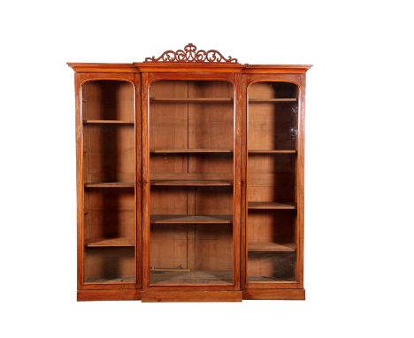 Victorian breakfront mahogany bookcase, pierced scroll work finial over a moulded cornice above three full length plain glass