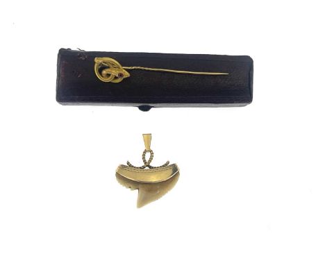 A 19th century gold ruby accent snake stickpin, and a gold mounted tooth pendant