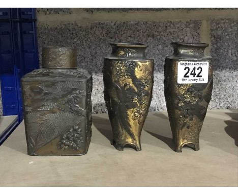 A pair of Japanese Meiji period bronzed vases, decorated with birds amongst flowering prunus branches, shouldered tapered for