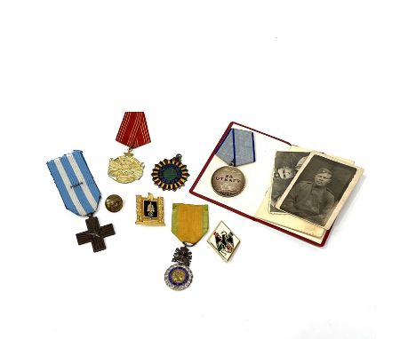 A collection of WWII medals and badges, including Yugoslavic Order of Bravery medal, French Medalille Militaire Republique Fr