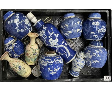 A collection of Chinese blue and white ginger jars, each decorated with flowering prunus branches, concentric blue ring marks