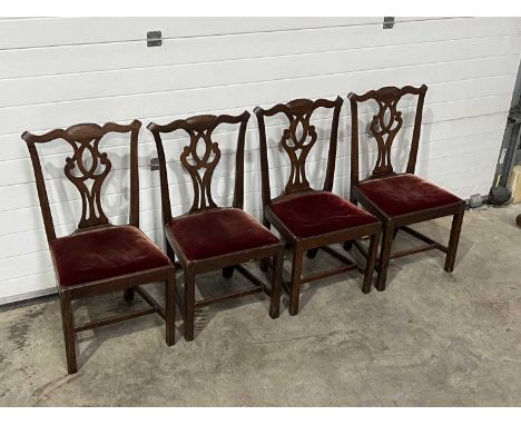 A set of four dining chairs of Chippendale design, with carved splats and drop in seats (4)