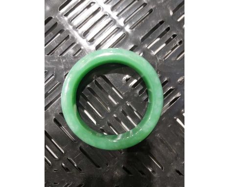 A Chinese jade bangle, 6cm wide