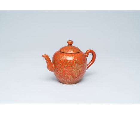 Full title: A Chinese coral red ground gilt decorated 'lotus flowers' teapot and cover, Qianlong mark, 19th/20th C.Descriptio