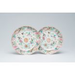 A pair of Chinese Canton famille rose English market 'Harrison' armorial plates with birds and butte