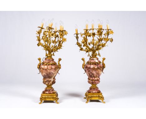 Full title: A pair of imposing seven-light gilt mounted marble candlesticks with putti and floral design, 20th C.Description: