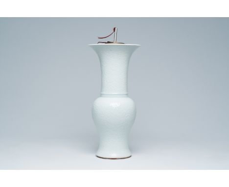 Full title: A Chinese white glazed yenyen vase with anhua design mounted as a lamp, QingDescription:H 53 cm (incl. the mounts