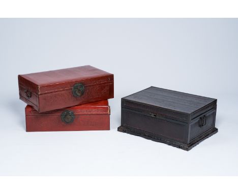 Full title: A pair of Chinese partly red lacquered leather travel trunks with floral design and a black lacquered trunk, 20th