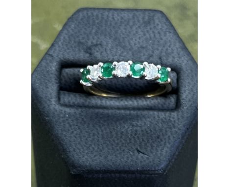 An emerald and diamond seven stone ring set in yellow gold, size R.