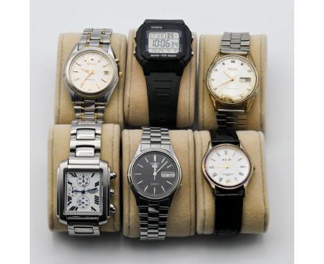 A collection of six wristwatches including three Seiko's, Casio, Avia, Amadeus in watch display case.