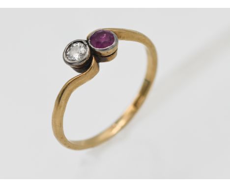 An 18ct yellow gold diamond and ruby twist ring, size N.