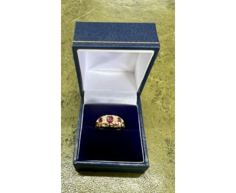 An 18ct yellow gold diamond and ruby ring, size M/N