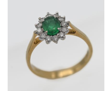 An 18ct yellow gold diamond and emerald cluster ring, size O/P.