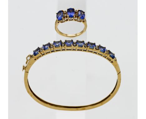 A 14k yellow gold bangle set with diamonds and tanzanite's, approx total weight of tanzanite 5.25ct and approx weight of diam