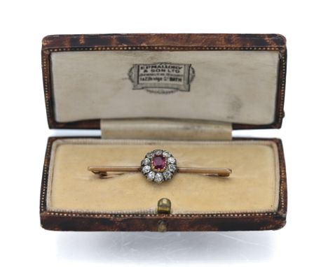 A ruby and diamond cluster brooch (not marked), approx weight 2.81g.