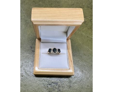 An 18ct yellow gold diamond and sapphire cluster ring, size K.