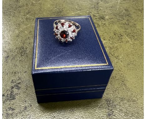 A 9ct gold garnet and diamond cluster ring, size O