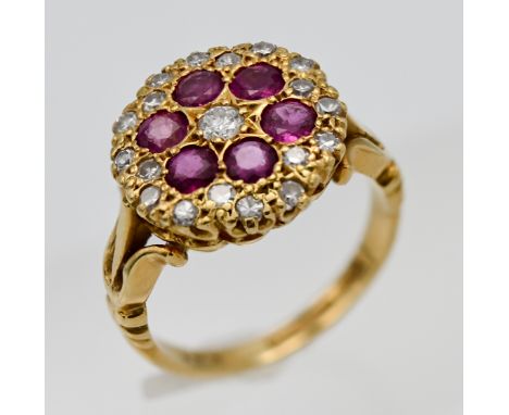 An Edwardian style 18ct yellow gold diamond and ruby cluster ring, size K/L, stamped PJC
