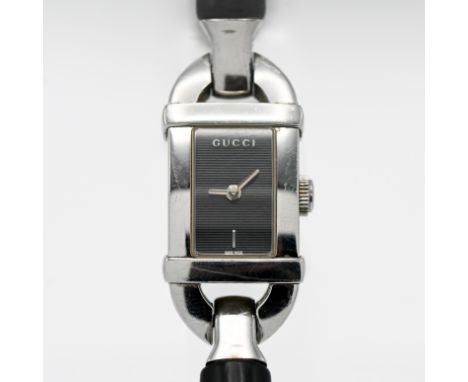 Gucci, a ladies rectangular black linen dial, leather bangle, model number 6800L, boxed.