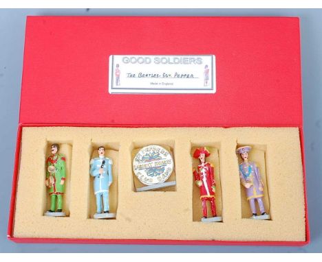 Good Soldiers, a boxed set of painted lead figures of all four Beatles in Sgt Pepper costumes, with drum, in original box.