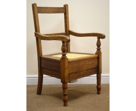 19th century country commode armchair, ladder back, daisy chain cane seat, on turned supports, W56cm Condition Report Click h