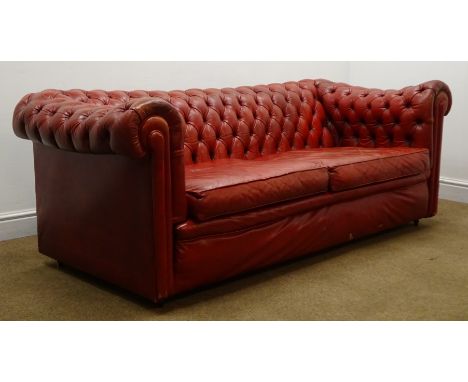 Two seat Chesterfield sofa upholstered in deep buttoned vintage red leather on castors, W185cm Condition Report Click here fo