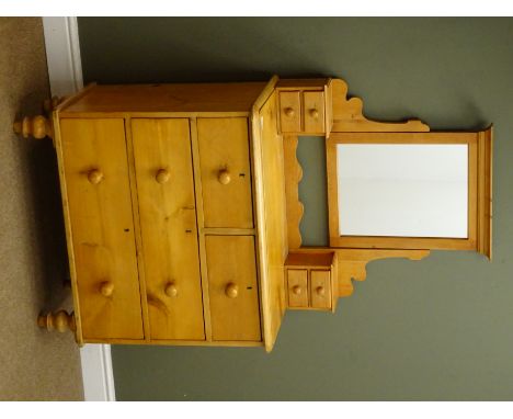 Victorian pine dressing chest, raised mirror back, four trinket drawers above two short and two long drawers, turned supports