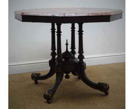 Victorian mahogany octagonal table, four turned column joined by central finial on four sabre supports with acanthus scroll f