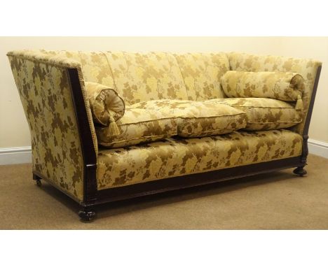 Early 20th century mahogany framed three seat sofa, scrolled arms, turned supports on castors, upholstered in floral gold fab