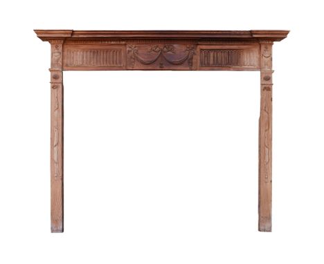 GEORGE III PINE FIRE SURROUND LATE 18TH CENTURY the inverted breakfront beaded shelf over an entablature with carved ribbon-t