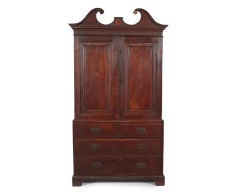 EARLY GEORGE III OAK PRESS CUPBOARD 18TH CENTURY the moulded swan neck pediment centred by a star motif, above a fluted friez