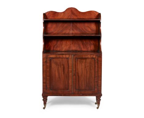REGENCY MAHOGANY WATERFALL BOOKCASE EARLY 19TH CENTURY with two open shelves, above a pair of panel doors outlined with bandi