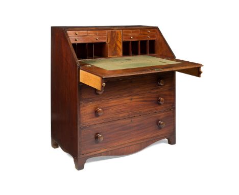 GEORGE III MAHOGANY BUREAU LATE 18TH CENTURY the slant front enclosing a fitted interior with pigeon holes and drawers, above
