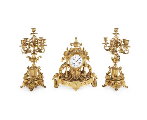 FRENCH LOUIS XV STYLE GILT BRONZE THREE PIECE CLOCK GARNITURE 19TH CENTURY the circular white enamel dial with Roman and Arab