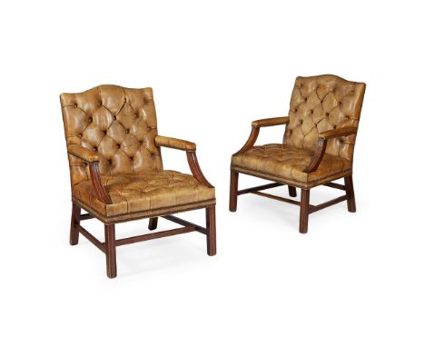 PAIR OF GEORGIAN STYLE LEATHER UPHOLSTERED MAHOGANY LIBRARY ARMCHAIRS 20TH CENTURY the serpentine top rails above button upho