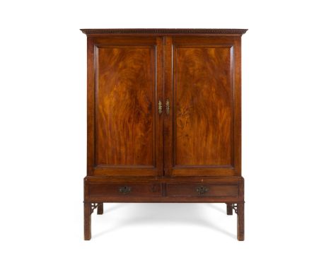 GEORGE III MAHOGANY CABINET-ON-STAND 18TH CENTURY the dentil moulded cornice, above a pair of panelled doors enclosing a shel