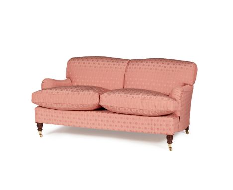 TWO SEAT SOFA, BY HOWARD CHAIRS LTD. MODERN with a two cushion seat and turned mahogany legs with brass caps and castors, cov