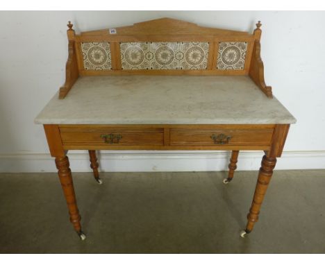 A late Victorian marble top ash two drawer washstand with a tiled back - Height 1.02 m x Width 1 m x Depth 51 cm