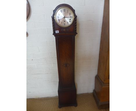 An 8 day granddaughter oak case clock with Westminster chimes - 1.34m tall - working with key