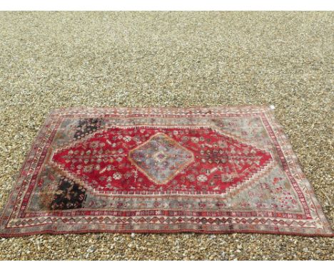 An Antique Persian Quashgai red and grey ground carpet - 240 cm x 157 cm 
Condition report: Some staining