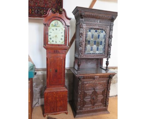 A thirty hour longcase clock with a painted arched dial with a calendar - in an oak and mahogany case with a swan neck pedime