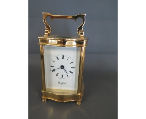 A modern brass and glass carriage clock/timepiece - movement stamped - made in England - 7 Jewels with panels of bevelled gla