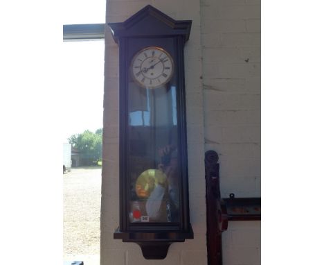 A 19th century ebonised single weight Vienna wall clock with weighted pendulum and key
