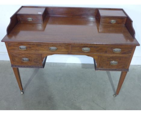 An Edwardian side table with an arrangement of six drawers bearing a Maple and Co  label - Height 87 cm x Width 1.22 m x Dept