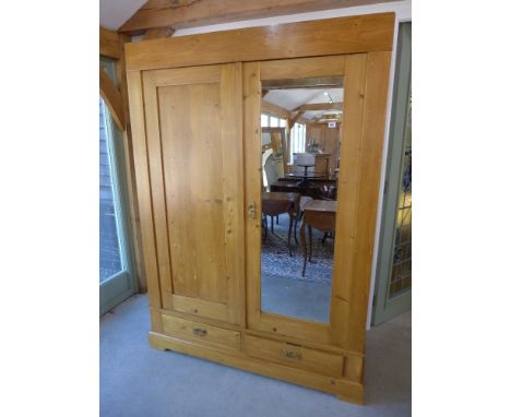 A fully sectional stripped pine two door wardrobe, one with mirror with two drawers below - circa 1930 - Height 1.99 m x Widt