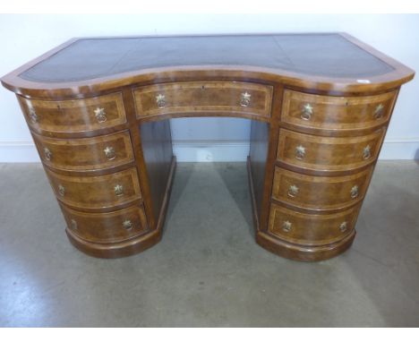 A new Victorian style walnut serpentine fronted nine drawer desk with a leather inset top - Height 78 cm x Width 1.34 m x Dep